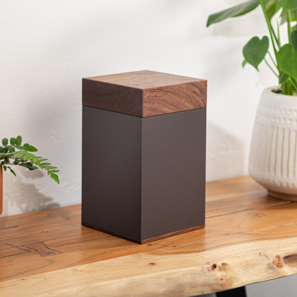 The Langley in Black Walnut urn on desk